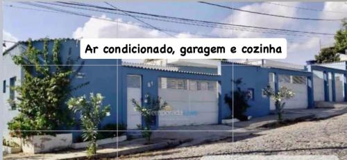 an old blue building with the words art combedomed gengen and c at Nº11- Mini Apto 5 min do Centro ar cond, cozinha e garagem in Divinópolis