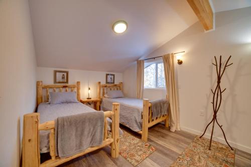 a bedroom with two beds and a window at Kenai River Retreat about 4 Mi to Morgans Landing! in Sterling