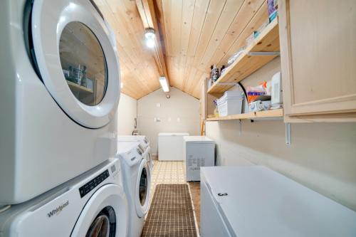 a laundry room with a washer and dryer at Studio Steps to Kenai River with Fire Pit! in Sterling
