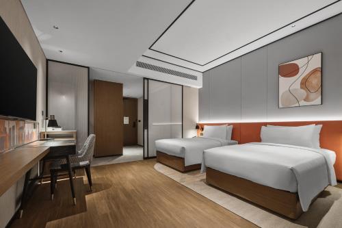 Ένα ή περισσότερα κρεβάτια σε δωμάτιο στο Hilton Garden Inn Beijing Yizhuang