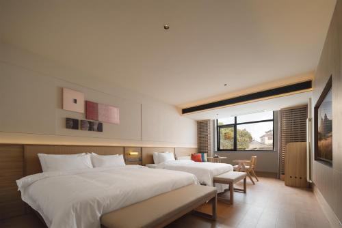 Postel nebo postele na pokoji v ubytování Maiyue Hotel-Xi`an Zhonggulou