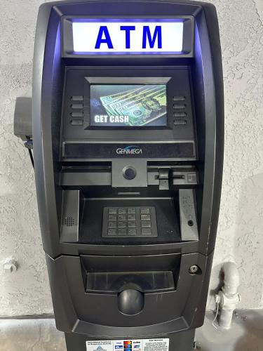 an atm machine with a sign on top of it at beach inn motel in Huntington Beach