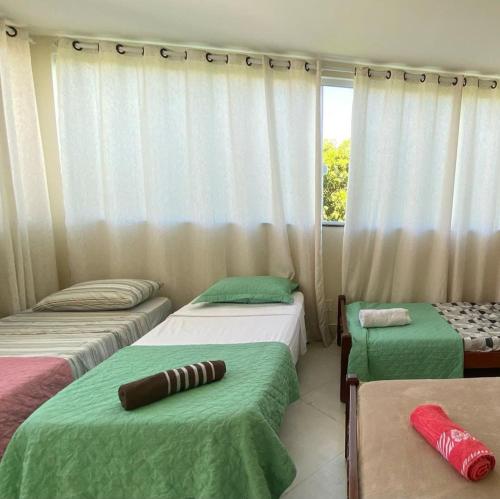 Postel nebo postele na pokoji v ubytování CASA EM BUZIOS OASIS 5 SUITES ATE 14 PESSOAs