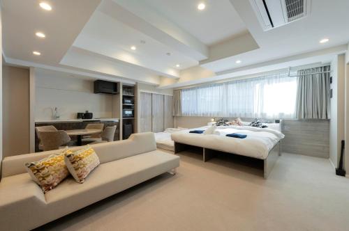 a large bedroom with a bed and a couch at ENT TERRACE GINZA Premium in Tokyo