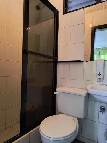 a bathroom with a toilet and a shower and a sink at Hostal María - Otavalo in Otavalo