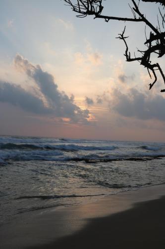 a view of the ocean from the beach at sunset at The Villa Sea Breeze in Talpe