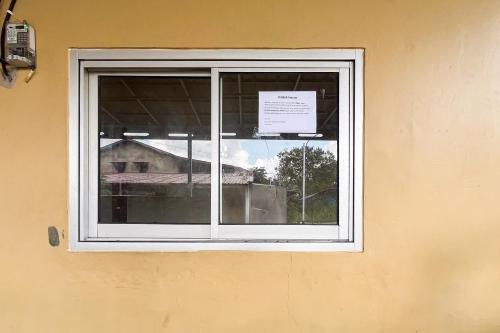 a window of a building with a sign on it at Good Sleep 4 RedPartner in Samarinda