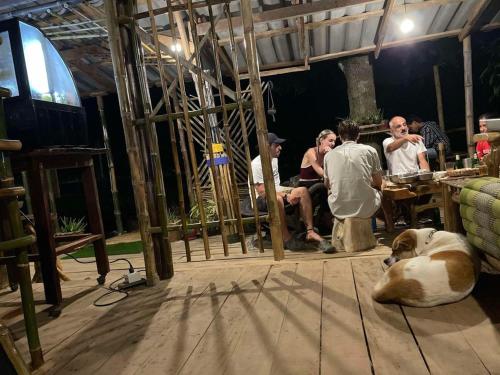 a group of people sitting in a room with a dog laying on the floor at Gaarawe, Khao Sok, Surat Thani Province, Thailande in Ban Bencha