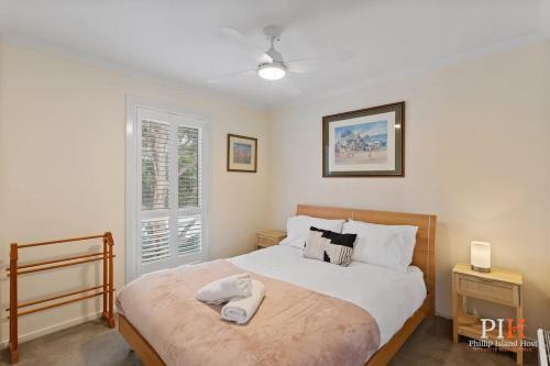 a bedroom with a bed with two towels on it at Tranquil Holiday Retreat Rhyll in Rhyll