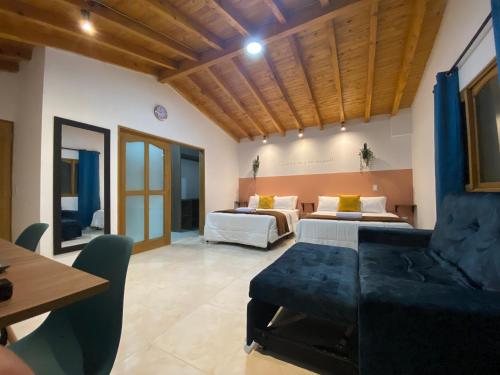 a living room with two beds and a couch at Fraternity Room - a solo una cuadra del parque in Carmen de Viboral