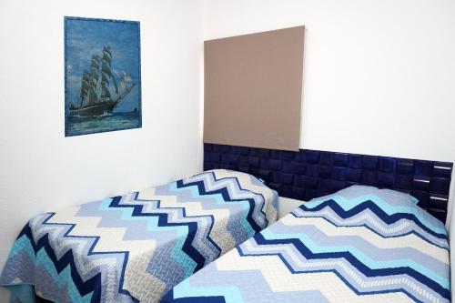 a bedroom with a bed and a picture on the wall at La Petite Santa Ana in Santa Ana