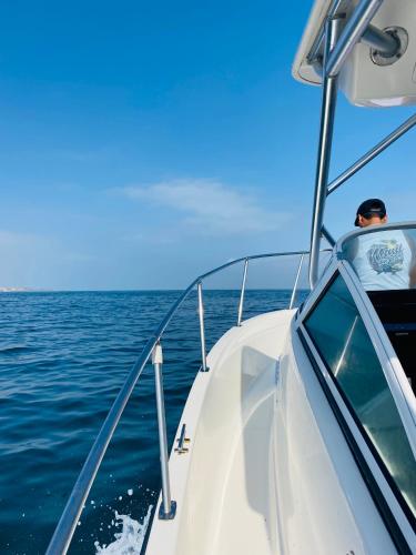 a man sitting on a boat in the water at casaNorte paraíso norteño mirador de Ballenas in Canoas De Punta Sal