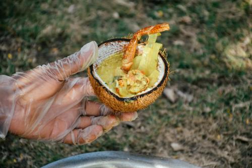 a person holding up a half eaten food item at Likuri Island Resort Fiji in Natadola