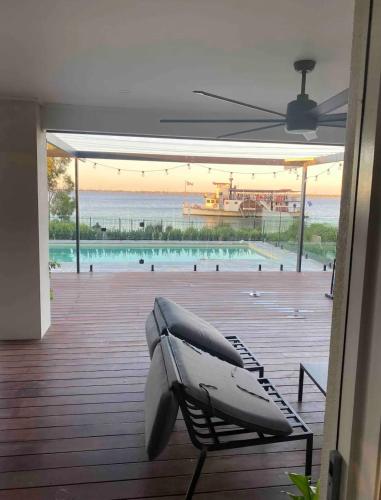 a bench on a deck with a view of a pool at Lakehouse in Yarrawonga