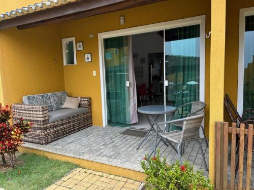 a screened in porch with a couch and a table at Imbassai Summer Flats Village in Imbassai