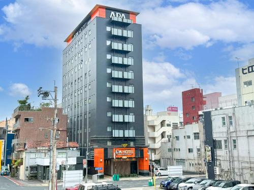 a tall building with aania on the top of it at APA Hotel Kagoshima Chuoekimae Nishiguchi in Kagoshima
