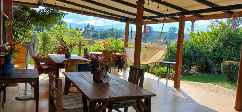 an outdoor patio with tables and chairs with a view at Country Retreat in Mae Rim