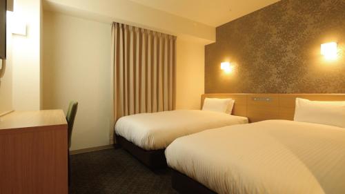 Postel nebo postele na pokoji v ubytování AB Hotel Sakaihigashi