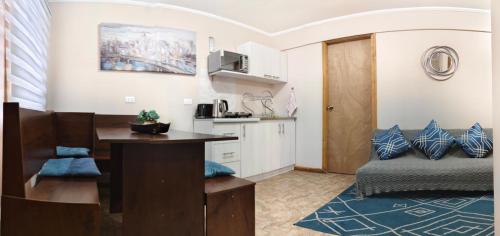 a living room with a desk and a couch at Departamentos Entre Lagos in Licán Ray