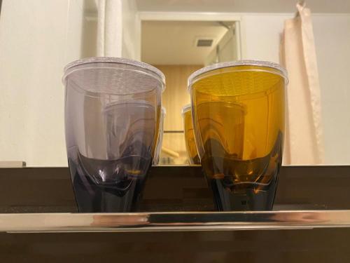 two glasses of wine sitting on a counter at Compass Hotel Nagoya in Nagoya