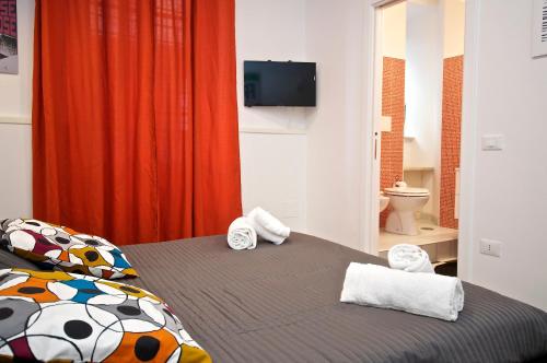 a bedroom with a bed with towels on it at Flaminio Butterfly House in Rome