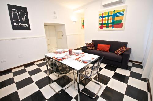 a living room with a table and a couch at Flaminio Butterfly House in Rome