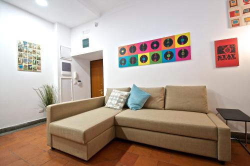 a living room with a brown couch in a room at Flaminio Butterfly House in Rome