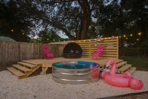 a backyard with a hot tub and a fire pit at family house cowboy pool HOT TUB Yard Games in Pensacola