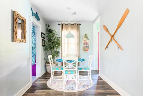 a dining room with a table and two chairs at family house cowboy pool HOT TUB Yard Games in Pensacola