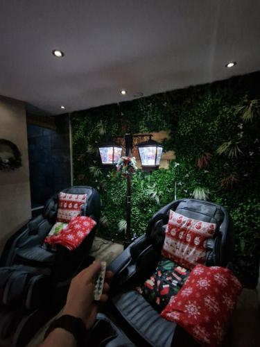a person holding a remote in a living room with two chairs at Ô Bonsaï Spa in Calais