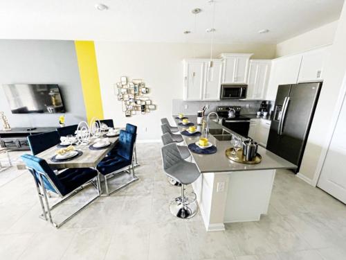 a kitchen with a table and chairs in a kitchen at Luxury 2bd 2 bath Condo Home 232 in Davenport