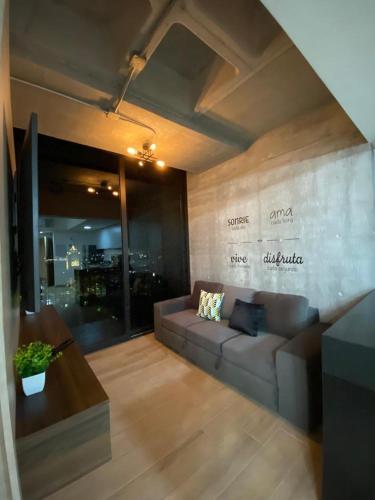 a living room with a couch and a table at Lux 2 bedroom apartment, swimming pool, gym and free parking spot in Macro Plaza area in Monterrey