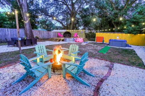 two chairs sitting around a fire in a backyard at family house cowboy pool HOT TUB Yard Games in Pensacola
