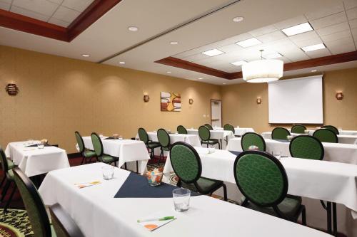 a conference room with white tables and green chairs at Courtyard Salt Lake City Layton in Layton