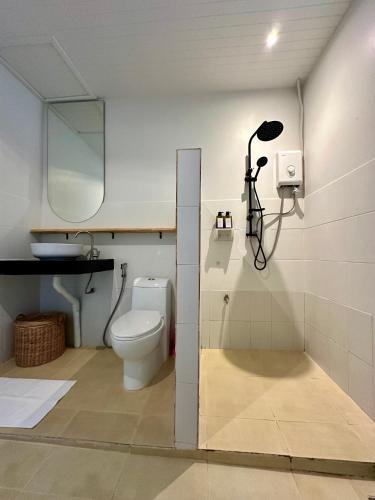 a bathroom with a toilet and a mirror at 2BD beachfront house in Chaloclum in Mae Haad