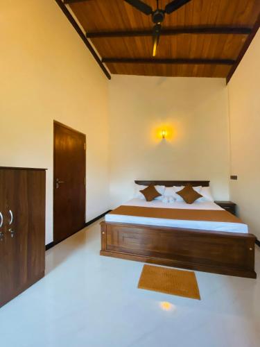 a bedroom with a large wooden bed in a room at Coco Bay Villa in Galle