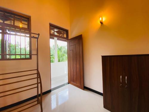 an empty room with a bunk bed and a door at Coco Bay Villa in Galle