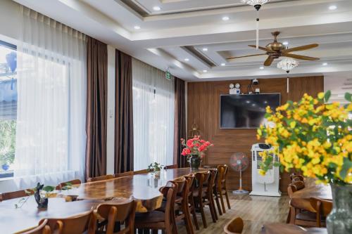 a dining room with a large table and chairs at 1 Stop ViVi An Bang Beach Hoi An Hotel in Hoi An