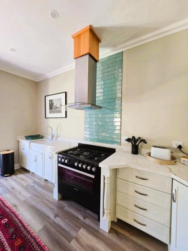 a kitchen with a stove and a sink at 2 Annie's Place Rawdons Country Estate in Nottingham Road