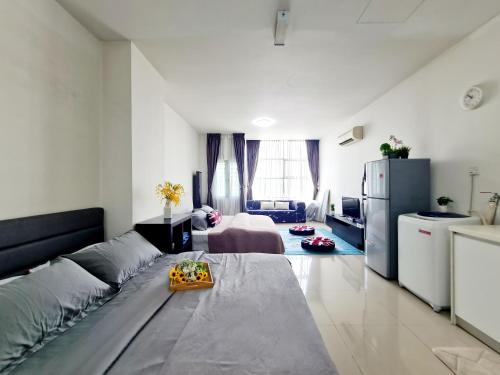 a living room with a couch and a refrigerator at First Subang Courtyard SS15 Subang Jaya SJMC Taylors Nu Empire Subang Parade Sunway Pyramid Lagoon Medical Centre LRT KTM in Subang Jaya
