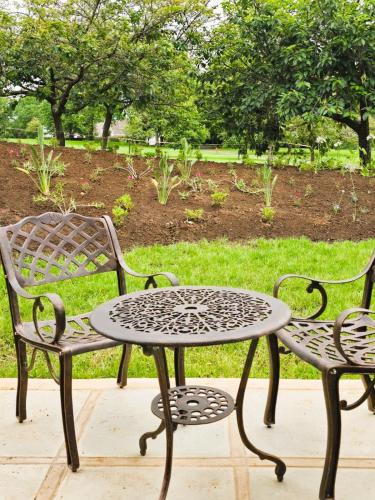 two chairs and a table and a table and chairs at 2 Annie's Place Rawdons Country Estate in Nottingham Road
