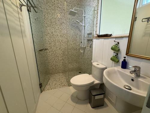 a bathroom with a shower and a toilet and a sink at Pailin Pool Villa,HuaHin in Hua Hin
