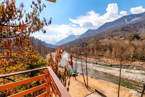 a view of a river from a balcony at Hotel 17 Miles Stone, Manali By Shivaneel Hospitality in Manāli