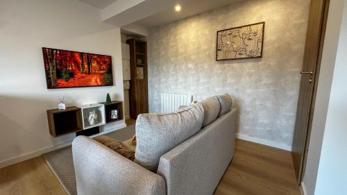 a living room with two chairs and a couch at Le Myosotis, Perle du Haut Doubs in Malbuisson