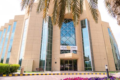 a building with a palm tree in front of it at eStay Hotel in Dubai