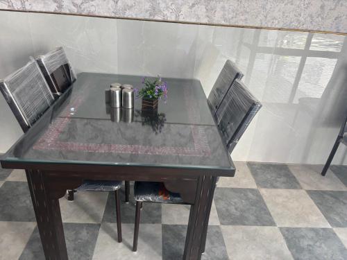 a table with four chairs and a plant on it at Hotel Hanuman Palace-450 meter Khatu Shayam Ji Temple in Khātu