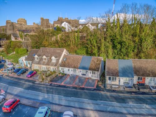 an aerial view of a house with cars parked in a parking lot at Butland Cottage in Pembroke