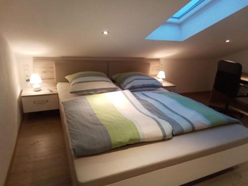 a bedroom with a large bed with two pillows at Deluexe Ferienwohnung Eckl in Prackenbach
