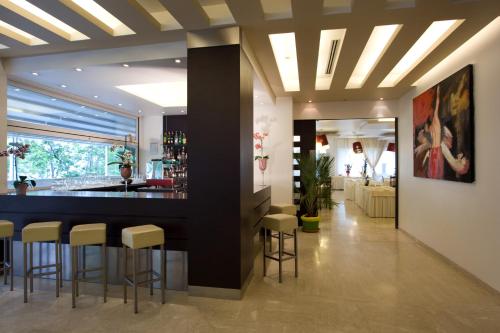 a lobby with a bar and stools in a building at Hotel Panama Majestic in Rimini