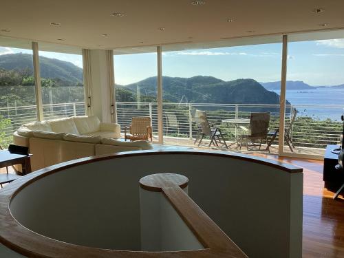 a living room with a view of the ocean at 貸別荘しおのか in Tokashiku